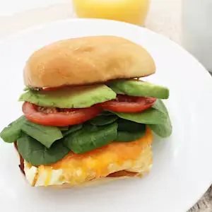 Avocado, Egg, and Cheese Sandwich (390 calories), featuring egg, creamy avocado, and melted cheese on toasted bread.