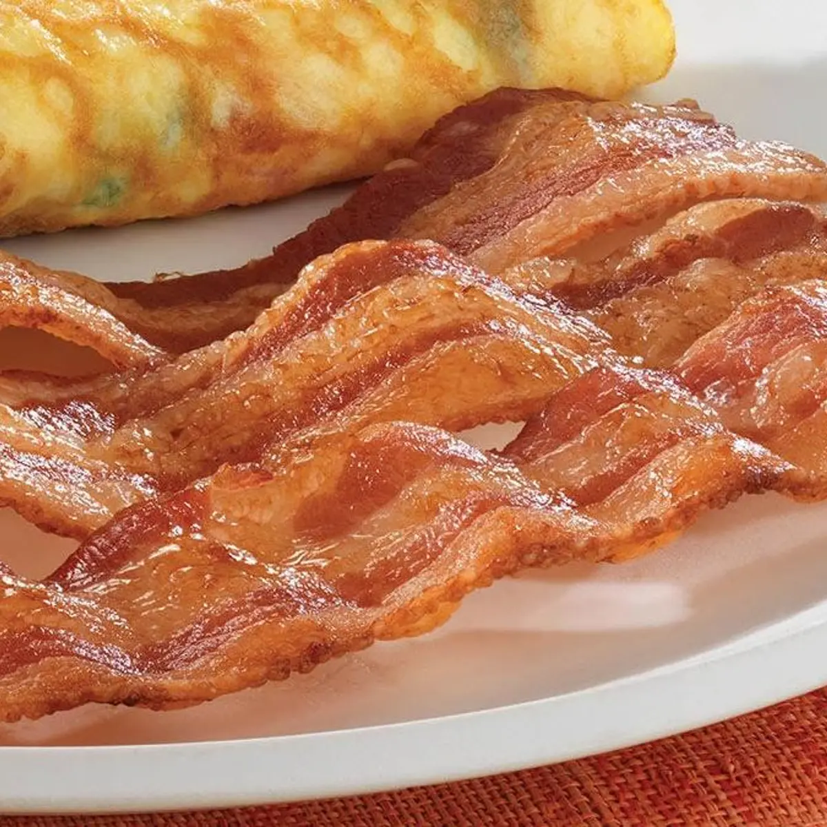 Bacon Strips (152 calories), featuring crispy, savory strips of bacon served as a breakfast side.