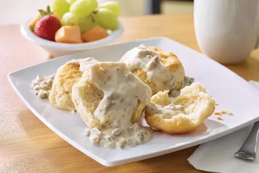 Biscuits & Gravy (390 calories), featuring warm, flaky biscuits topped with rich, savory country-style gravy.