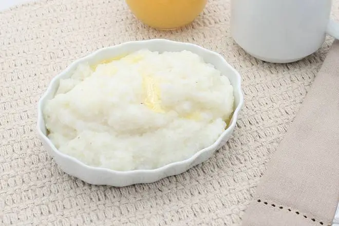 Grits (220 calories), featuring a warm, creamy bowl of classic grits served as a breakfast side.