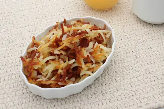 Hash Browns (440 calories), featuring crispy, golden-brown shredded potatoes served as a classic breakfast side.