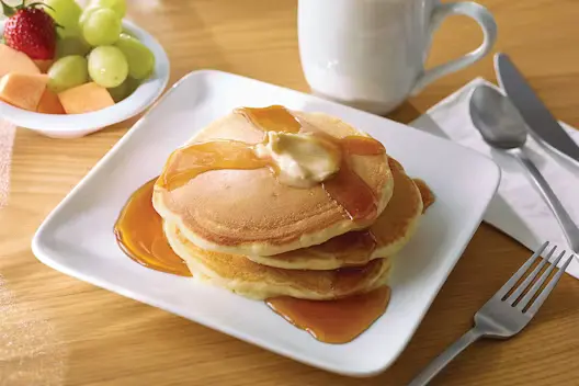 Pancakes (240 calories), featuring a stack of fluffy pancakes served warm.