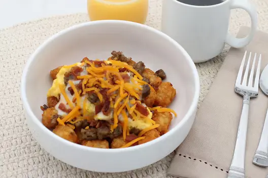 Sausage Breakfast Bowl (530–670 calories), featuring sausage, eggs, and hearty breakfast ingredients served in a warm bowl.