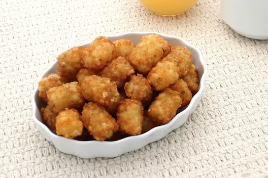 Tater Tots (340 calories), featuring crispy, bite-sized potato tots with a golden-brown exterior.